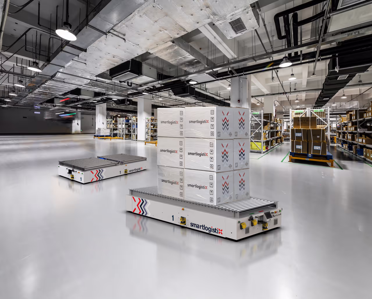 SmartLogistiX OmniFlex low-profile AMR transporting boxes through a warehouse