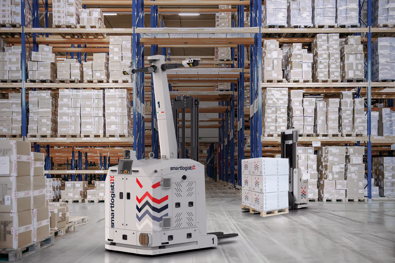 SmartLogistiX Jupiter AMR forklift robots navigating a warehouse aisle